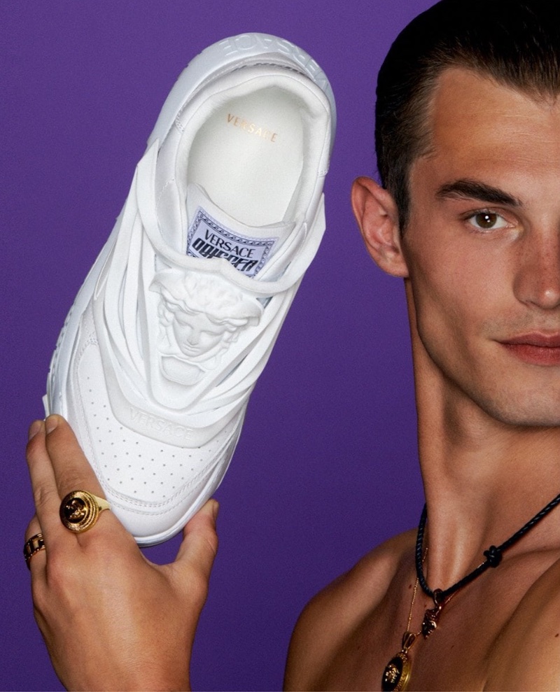 Appearing in a promotional image for Versace's holiday guide, Kit Butler holds the fashion brand's must-have Odissea sneakers.