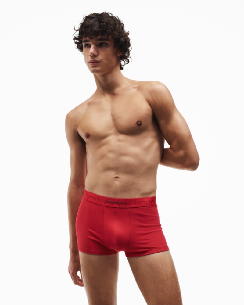 Fernando Lindez wears Calvin Klein Embossed Icon underwear in red for the brand's holiday 2022 campaign.