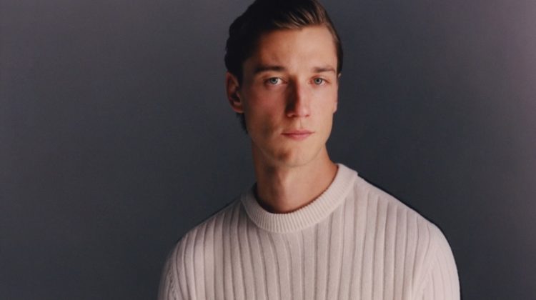 British model Harvey James dons a ribbed sweater from Dunhill's Archive Deco capsule collection.