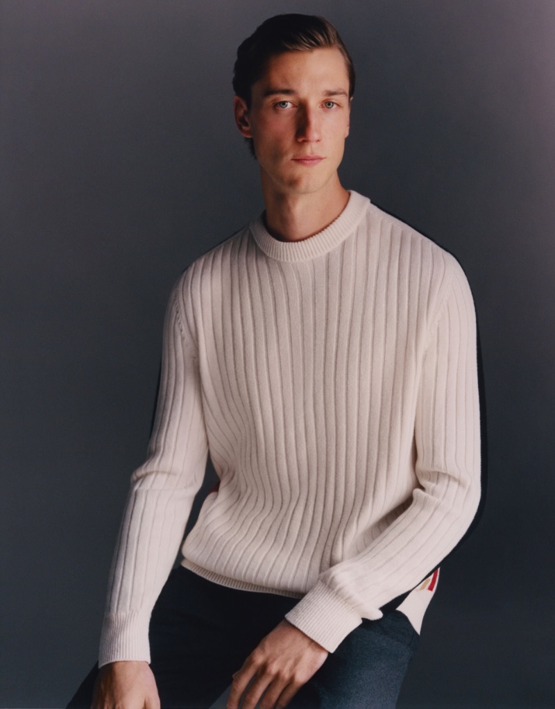 British model Harvey James dons a ribbed sweater from Dunhill's Archive Deco capsule collection.