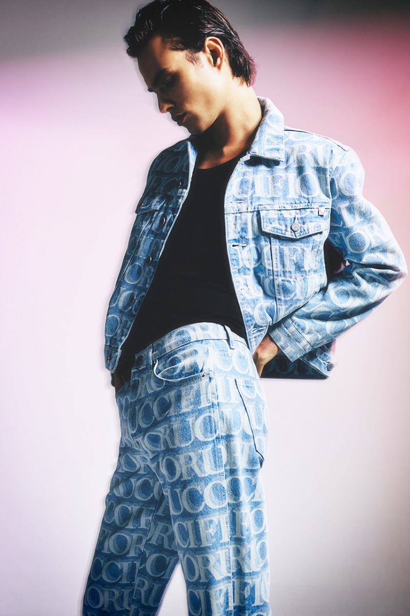 Louis Baines dons a Fiorucci logo-print denim jacket and jeans for the brand's pre-spring 2023 campaign.