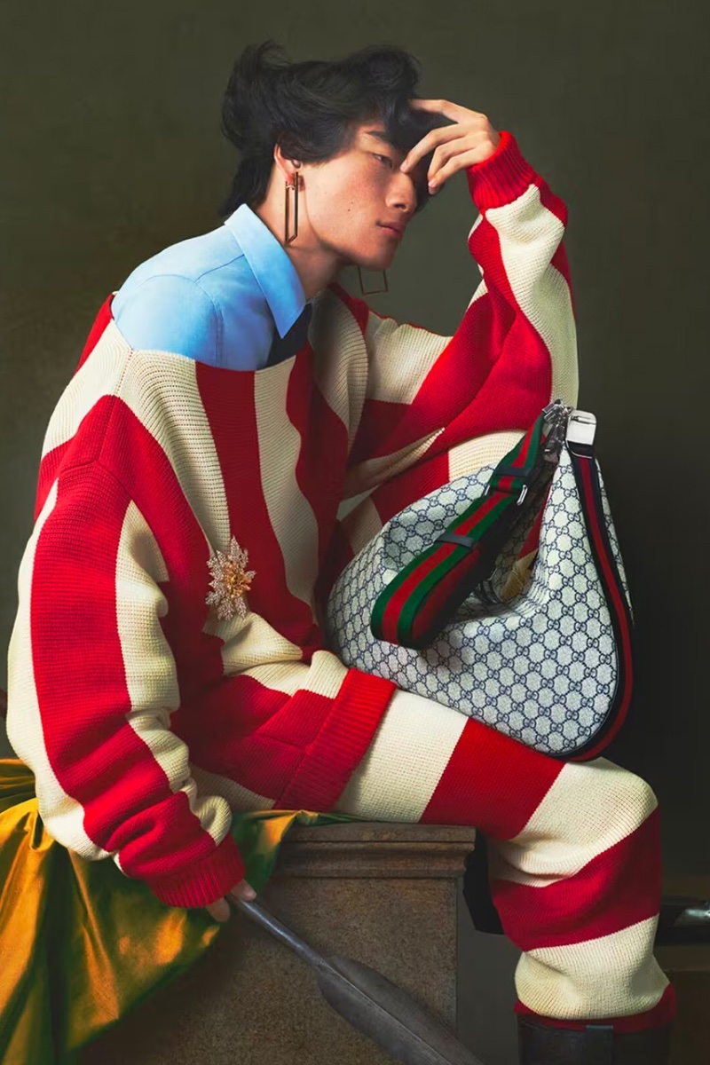 David Ge models a red striped knit look for the Gucci Cosmogonie cruise 2023 campaign.