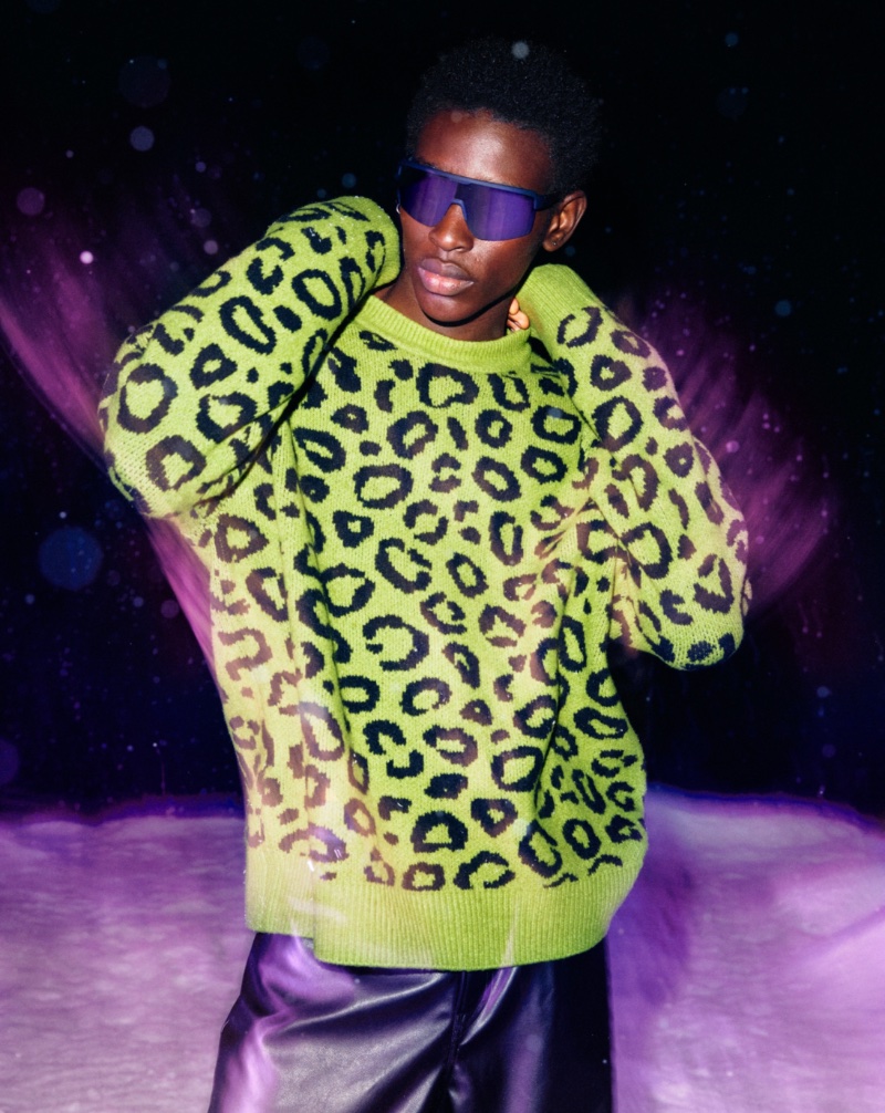 Adamu Bulus wears a leopard print oversized-fit jacquard-knit sweater.