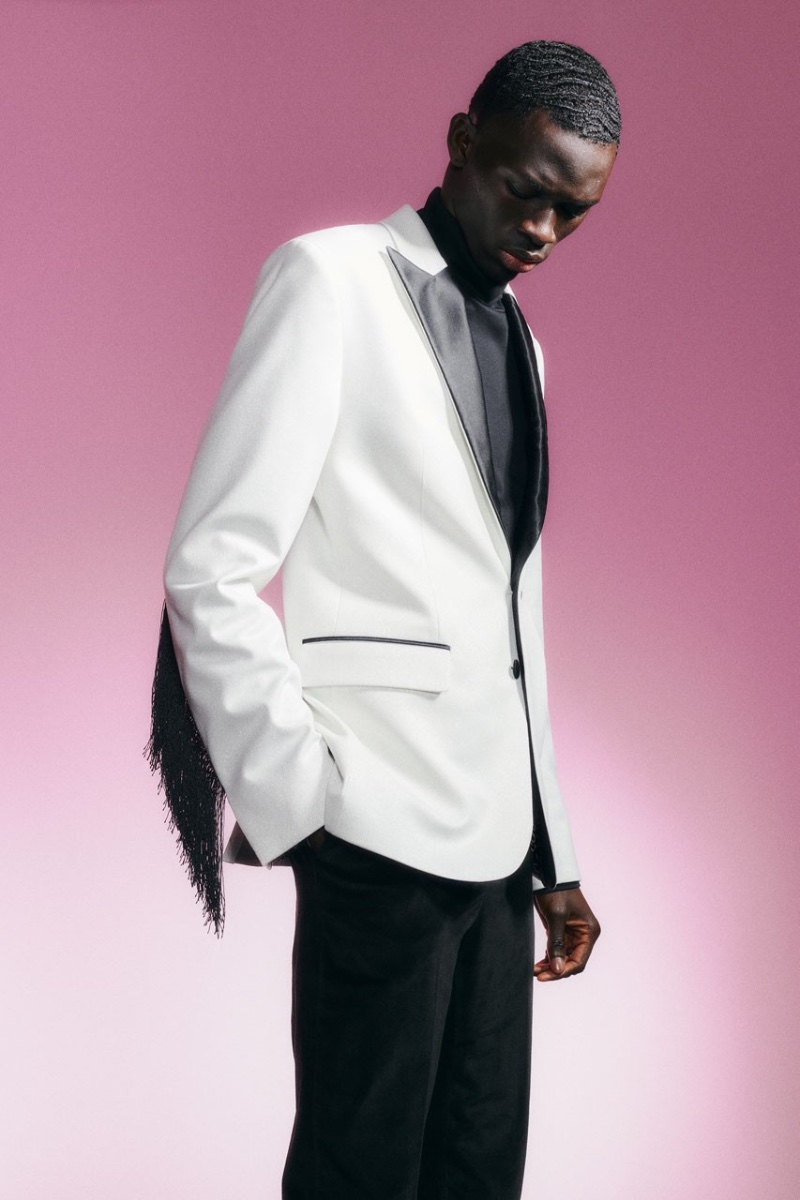Dressed to impress, Khadim Sock wears a white and black tuxedo jacket for J.Lindeberg's holiday 2022 campaign.