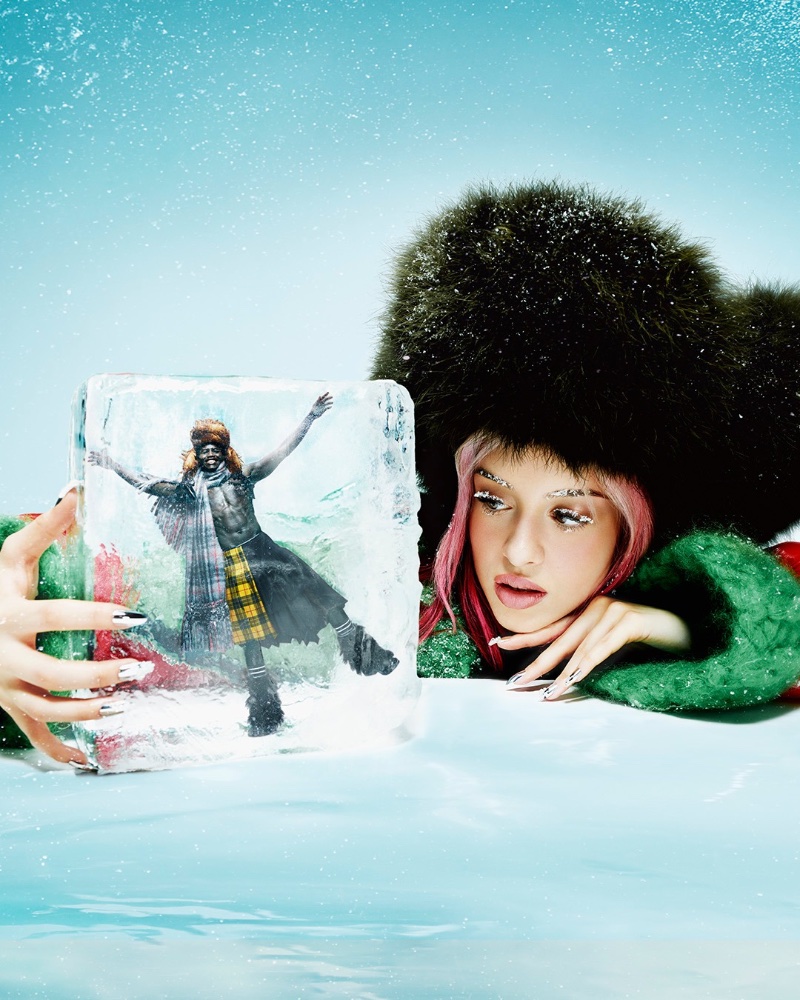 Model Bella Summers takes a look at a frozen Omar Sesay for Jean Paul Gaultier's holiday 2022 fragrance advert.