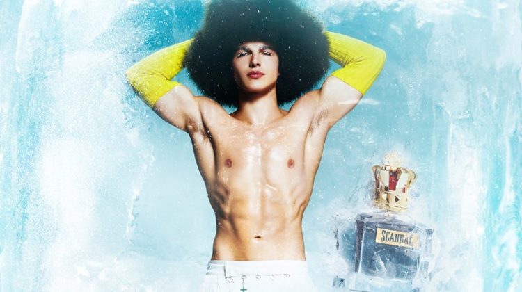 A shirtless Sacha Bilal flexes his abs for Jean Paul Gaultier's holiday 2022 fragrance campaign.