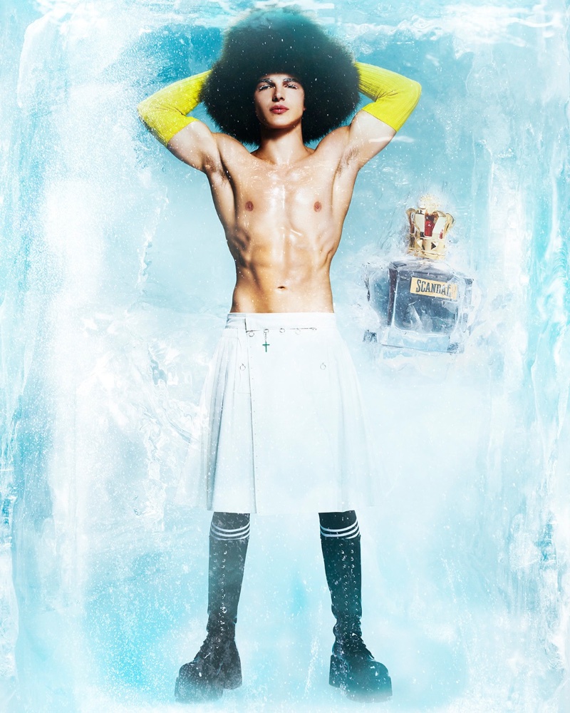 A shirtless Sacha Bilal flexes his abs for Jean Paul Gaultier's holiday 2022 fragrance campaign.