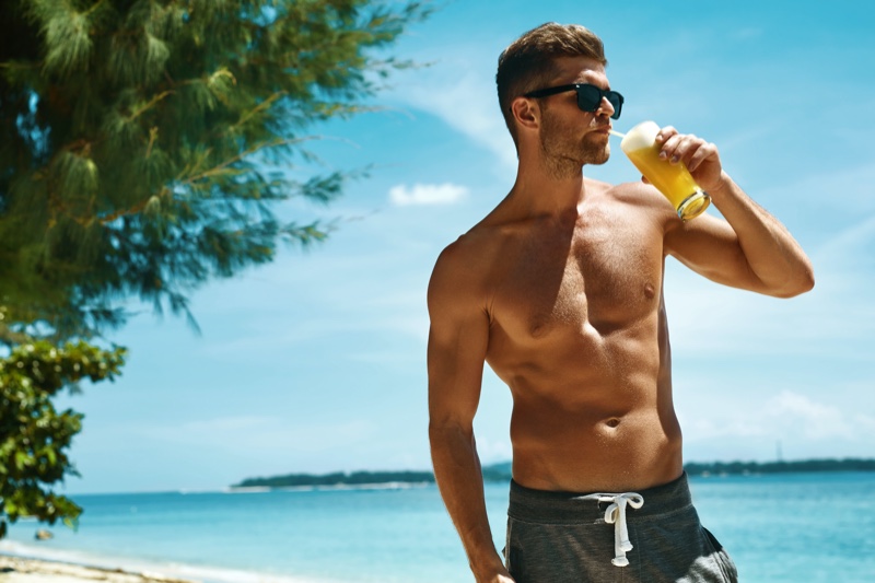 male model beach juice drink sunglasses