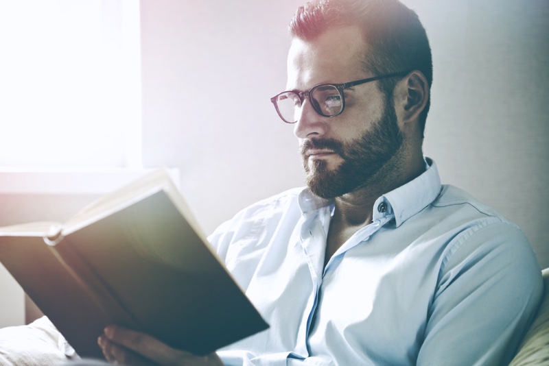 man glasses shirt reading book
