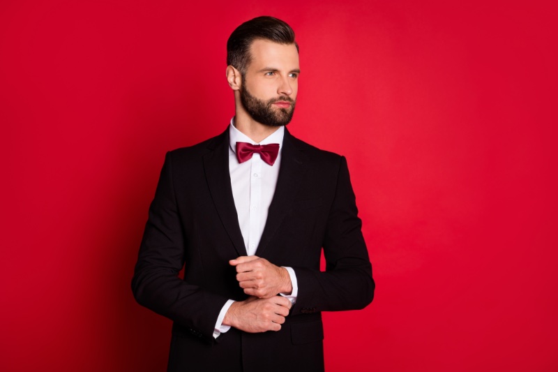man holiday tailoring red bow tie red background