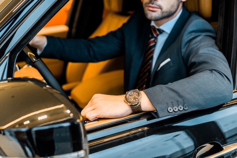 man luxury car suit watch