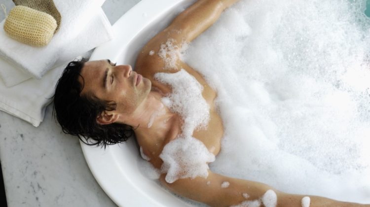 man soaking bubble bath