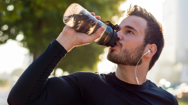 man working out drinking water
