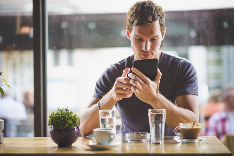 man on phone cafe » 10 Tips to Save Money on Your Next Pair of Sneakers man on phone cafe