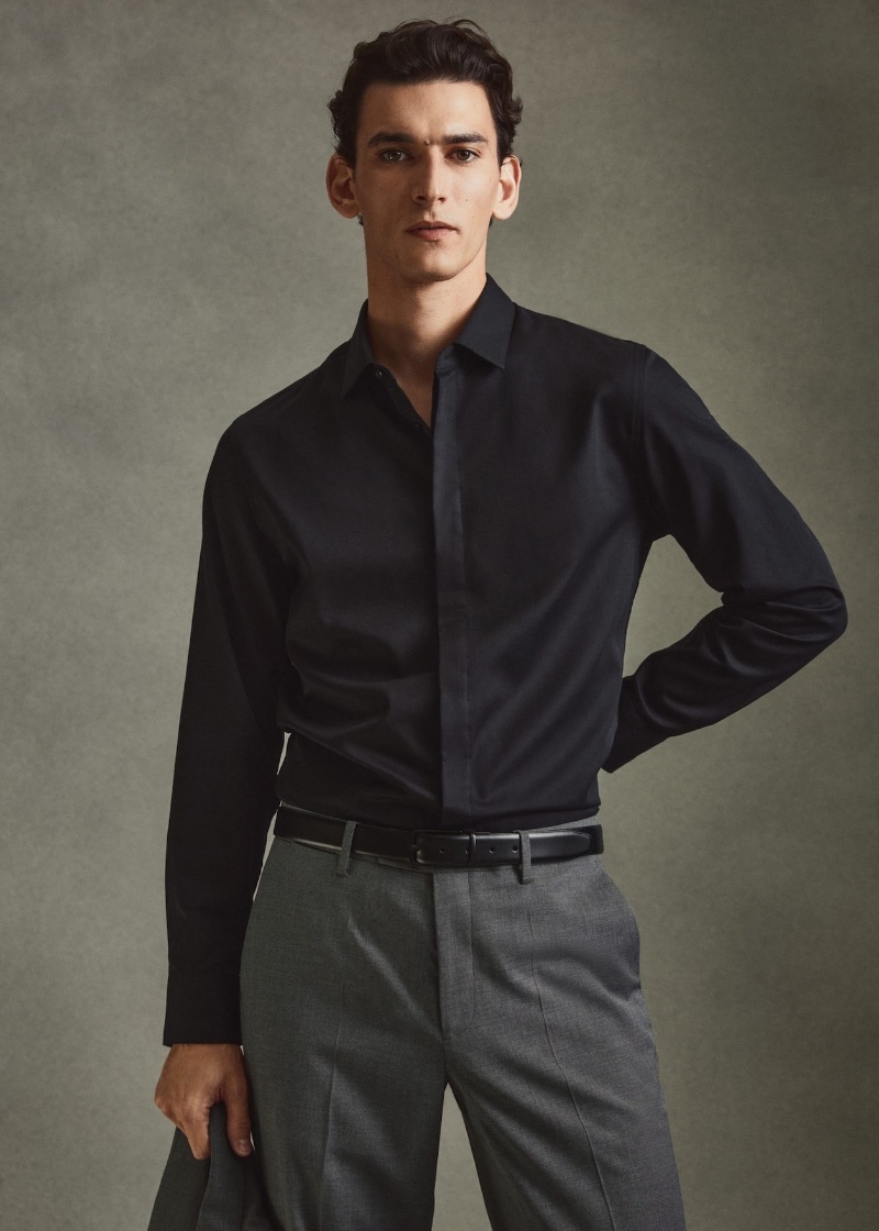 French model Thibaud Charon wears a Mango dress shirt in black with gray pleated suit trousers. » Mango Suits: Thibaud Dresses Up for the Occasion French model Thibaud Charon wears a Mango dress shirt in black with gray pleated suit trousers.