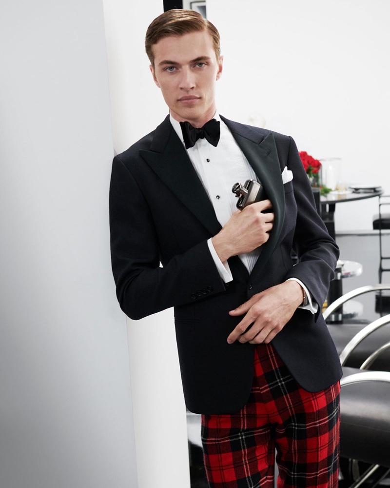 Dashing in a tuxedo jacket and red tartan trousers, Lucky Blue Smith fronts the Ralph's Club holiday 2022 campaign. 