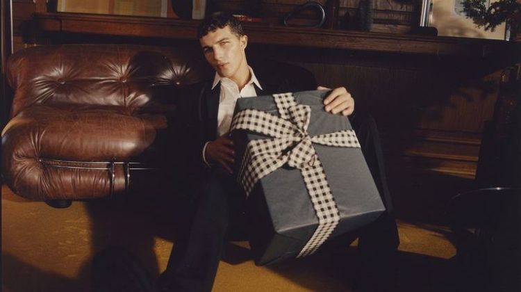 Taking hold of an oversized gift, Sacha Bilal fronts Sisley's holiday 2022 campaign.