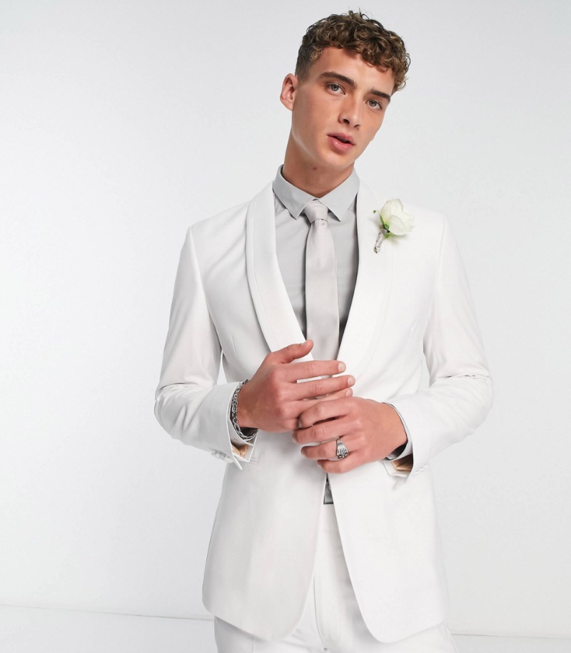 For a subtle but impactful look, break up your white suit with a pale gray shirt. 
