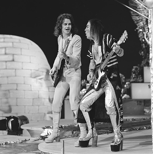 Wearing platforms and glam rock metallic fashions, Slade performs for Dutch television show AVRO's TopPop in 1973.
