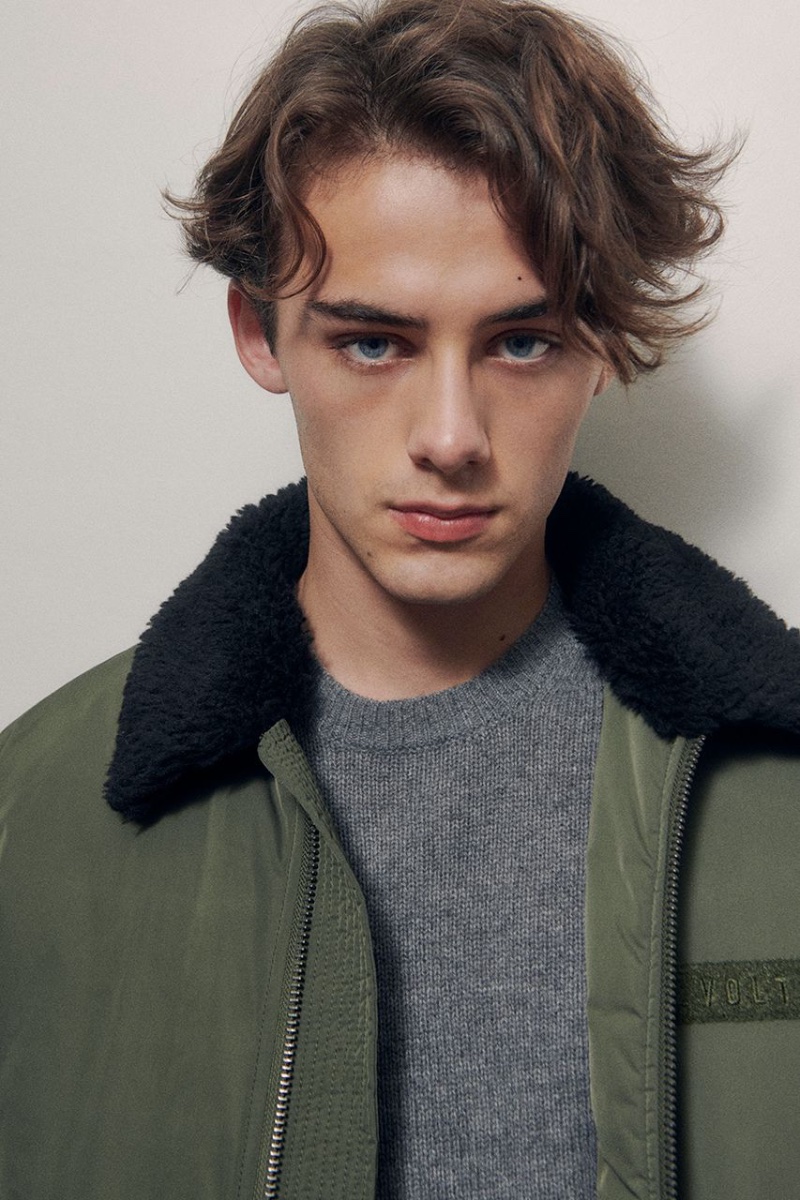 Taking the spotlight for Zadig & Voltaire, William Franklyn-Miller wears a green aviator-style jacket with a gray sweater. 