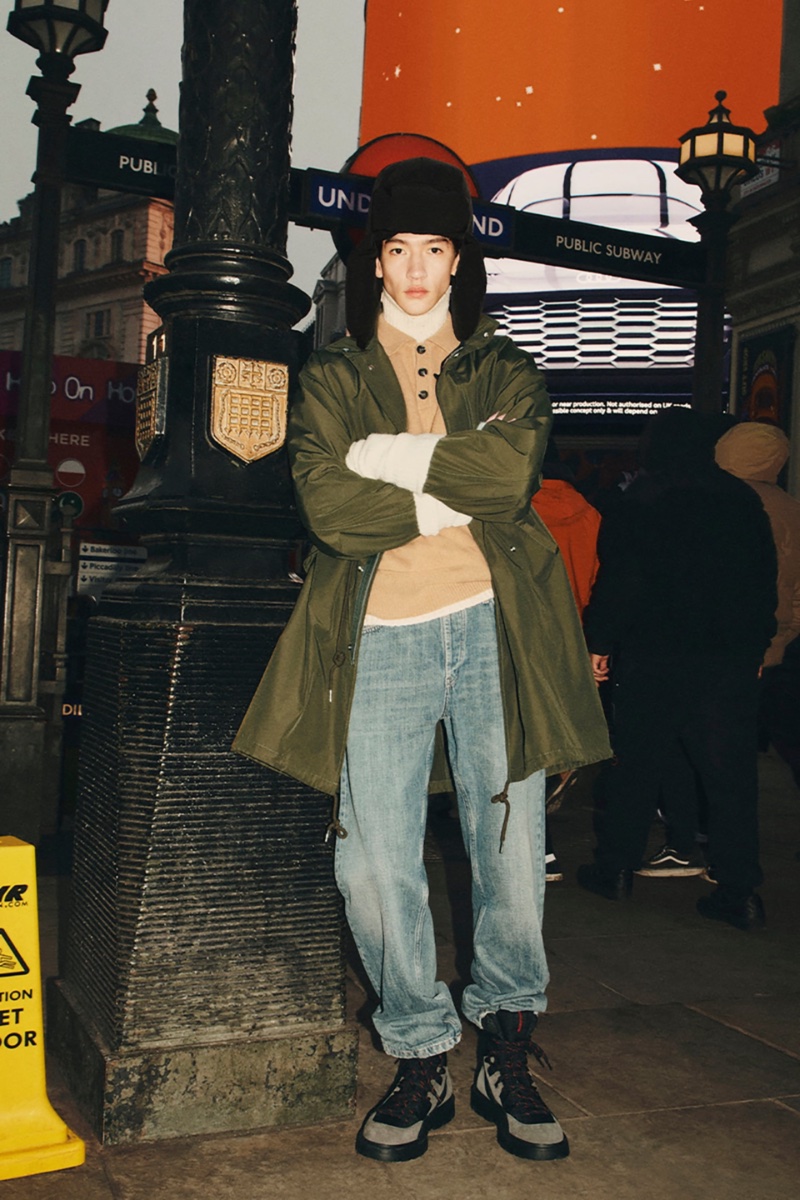 Dressed for winter, Felix Cheong-MacLeod wears a wool-blend knit polo shirt with a parka, straight-leg jeans, and a fur trapper hat.