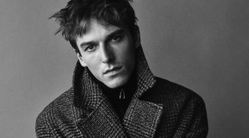 Connecting with Zara, Quentin Demeester wears the brand's plaid double-breasted men's coat.