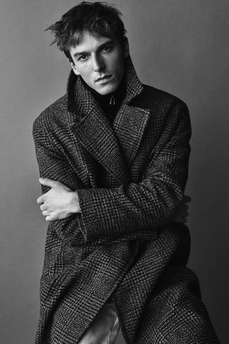 Connecting with Zara, Quentin Demeester wears the brand's plaid double-breasted men's coat. 