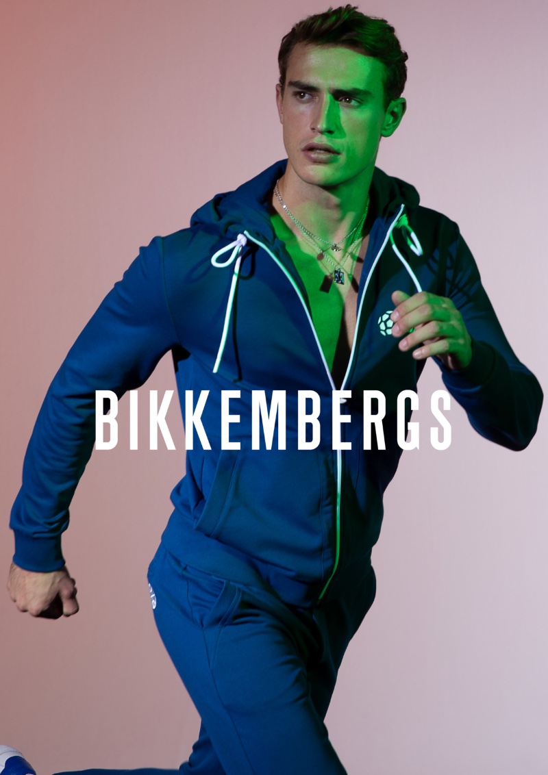 Sporty in a blue hoodie and track pants, Alex Verloop fronts Bikkembergs' spring-summer 2023 campaign.