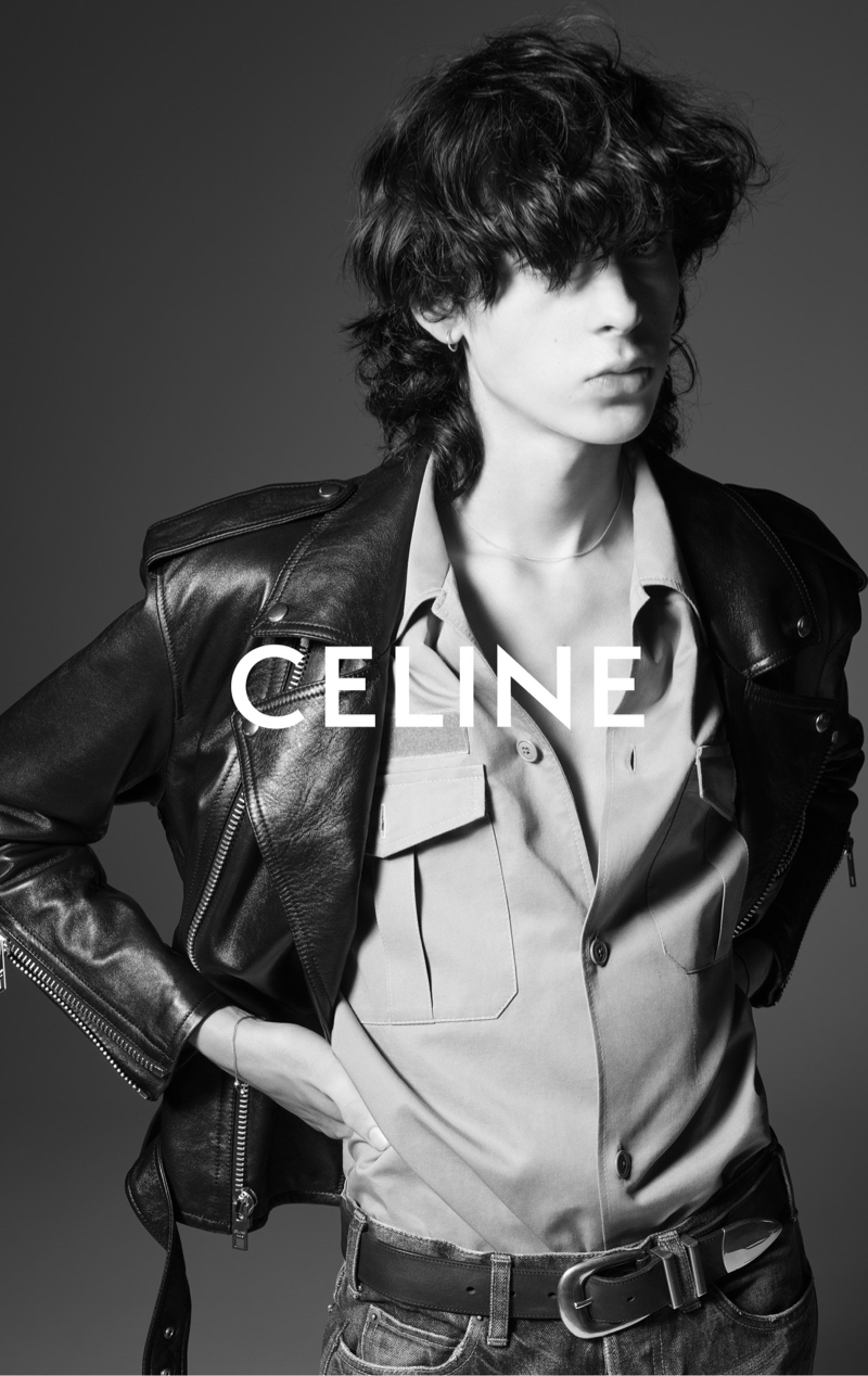Artie Aylott wears an army shirt with a leather biker jacket and jeans for Celine Homme's summer 2023 campaign. 