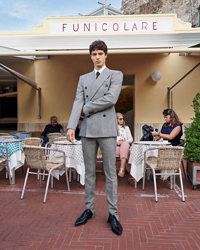 Dressed to impress, Nacho Penín models a gray double-breasted suit by Dolce & Gabbana. 
