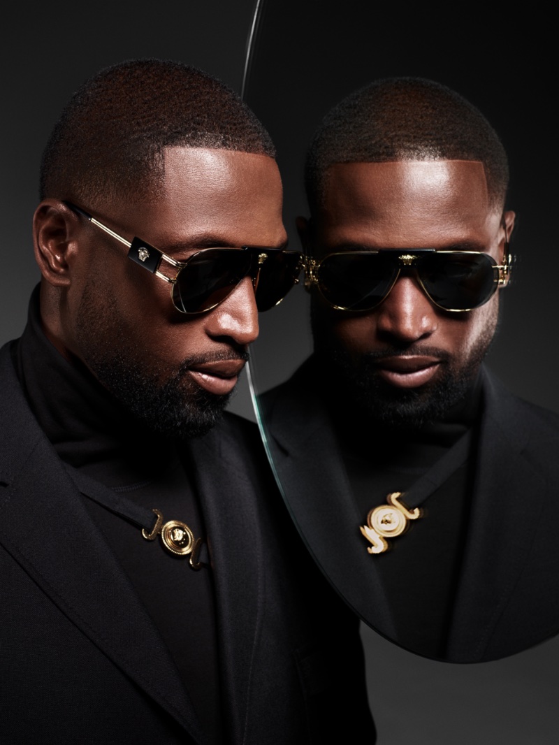 Dressed in all black with gold accents, Dwyane Wade fronts Versace's spring 2023 eyewear campaign. He rocks the Italian fashion house's VE2252 sunglasses.