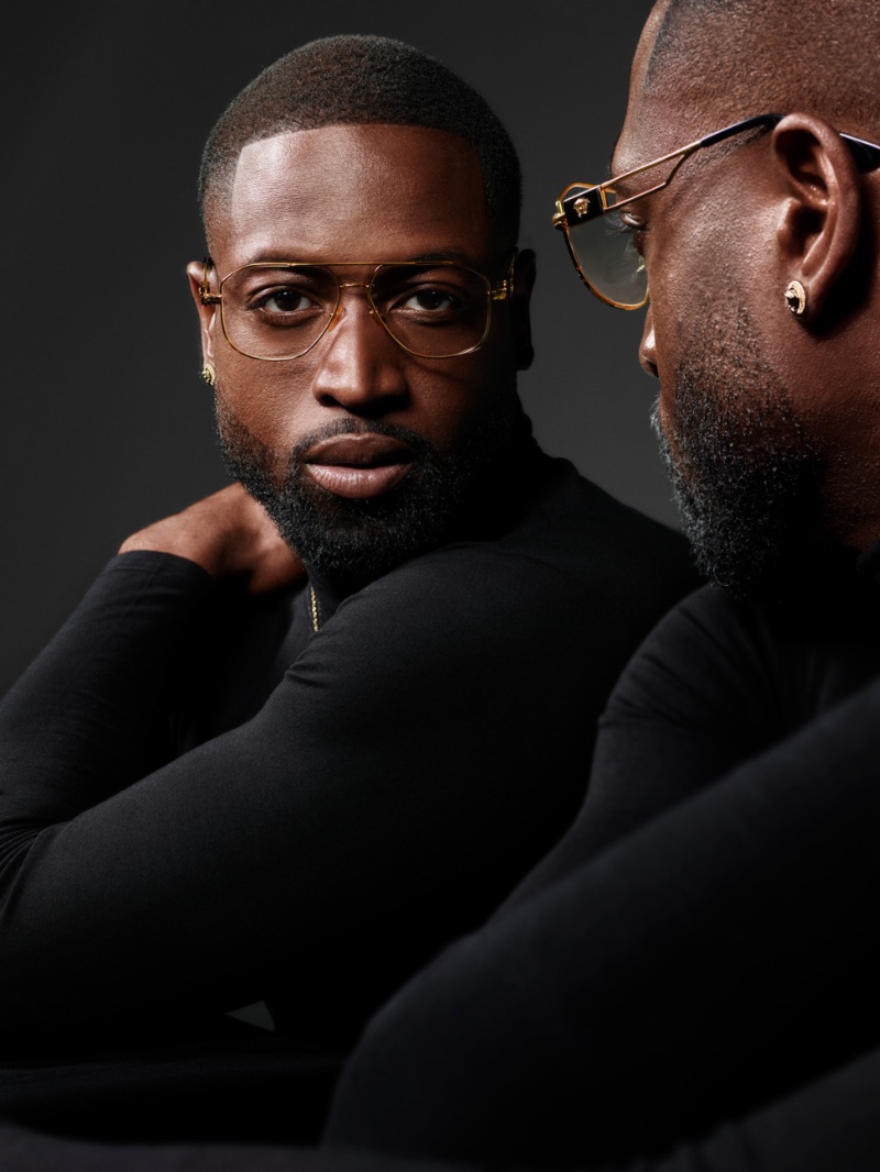 Versace enlists Dwyane Wade as the star of its spring 2023 eyewear campaign. Chic in a black turtleneck, Wade dons Versace's stylish VE1287 glasses.