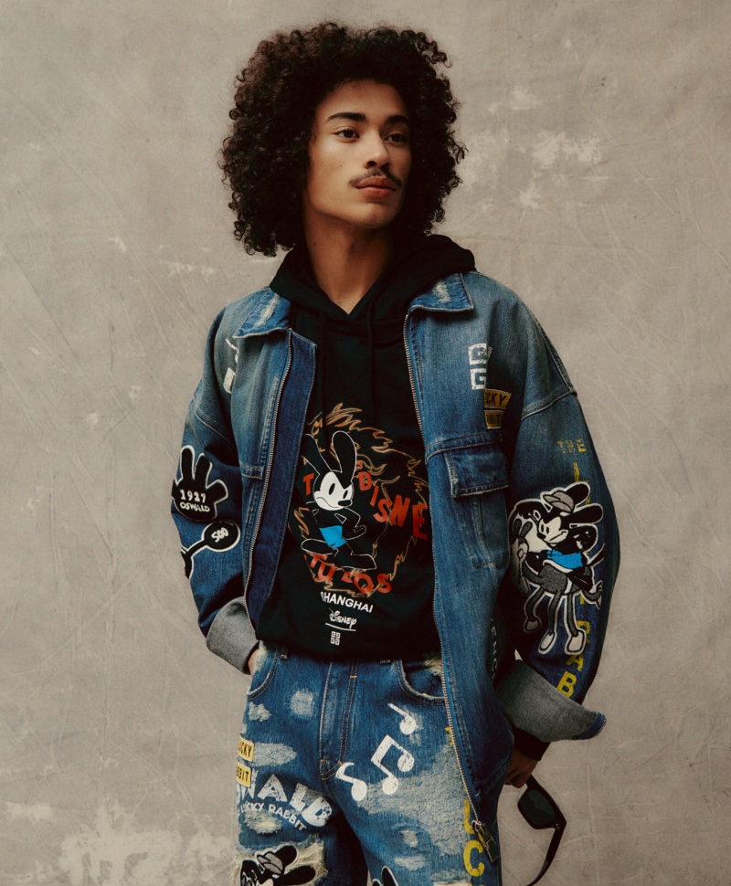 Making a graffiti statement, Lucian Príeto-Sánchez models a hooded t-shirt with a matching denim jacket and jeans from the Givenchy x Disney collection. 