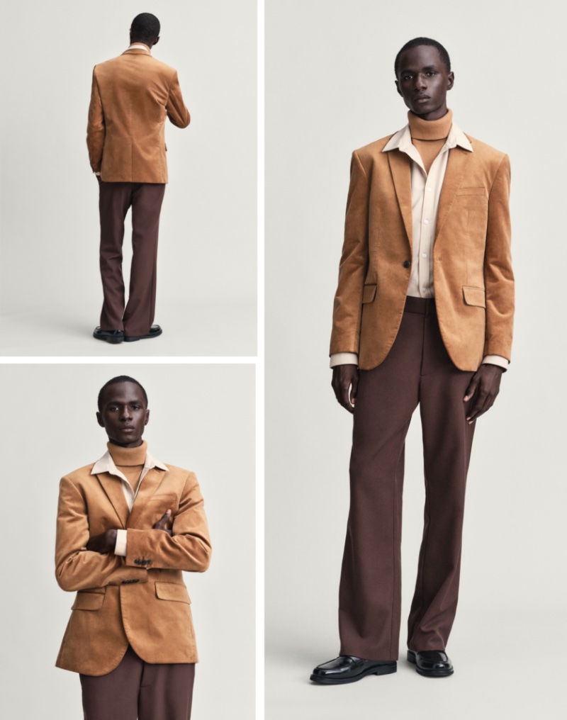 Model Malick Bodian channels '70s men's style in various shades of brown as he wears a suit jacket with a dress shirt, turtleneck, and flared trousers.