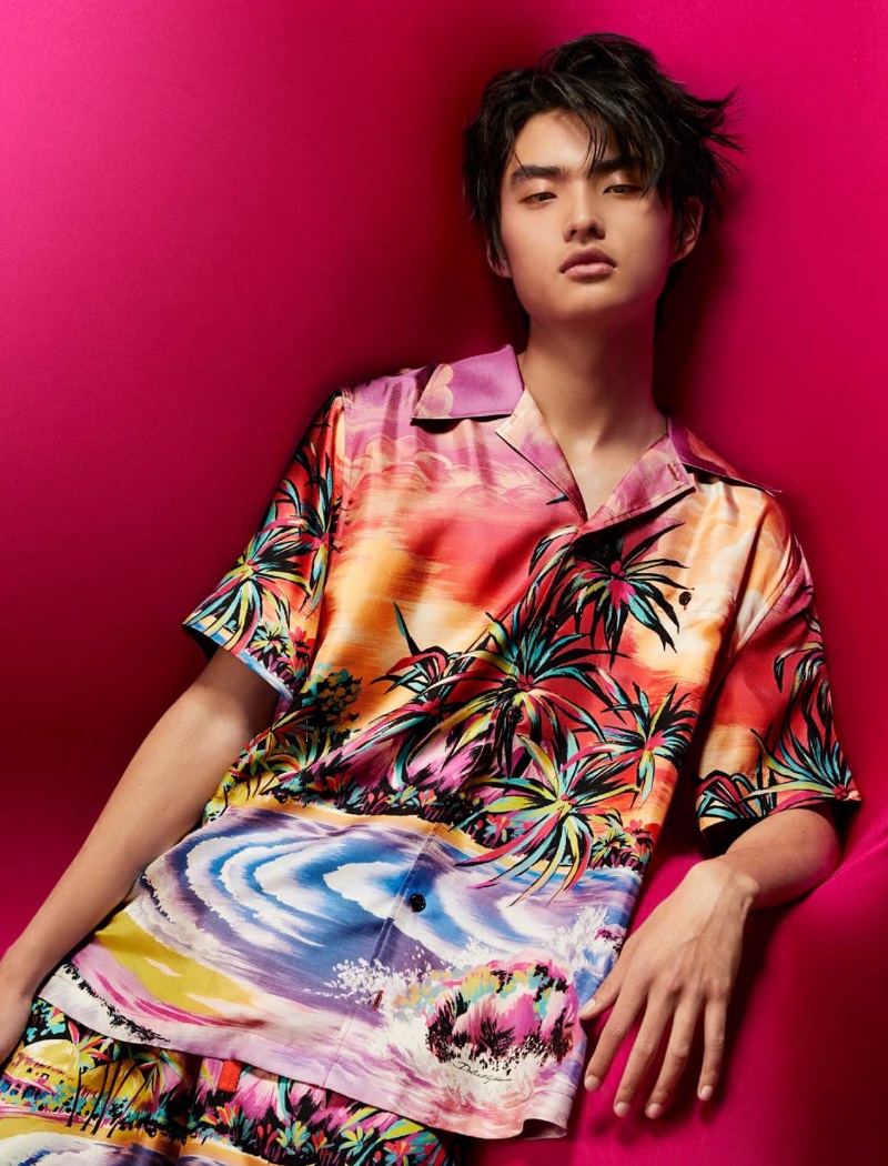 Embracing vibrant vacation style, Jialin Liu models a Dolce & Gabbana Hawaiian print silk shirt.
