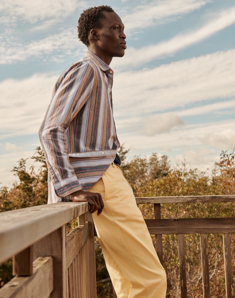 George Okeny sports a striped chambray shirt with straight-fit chinos by J.Crew. 