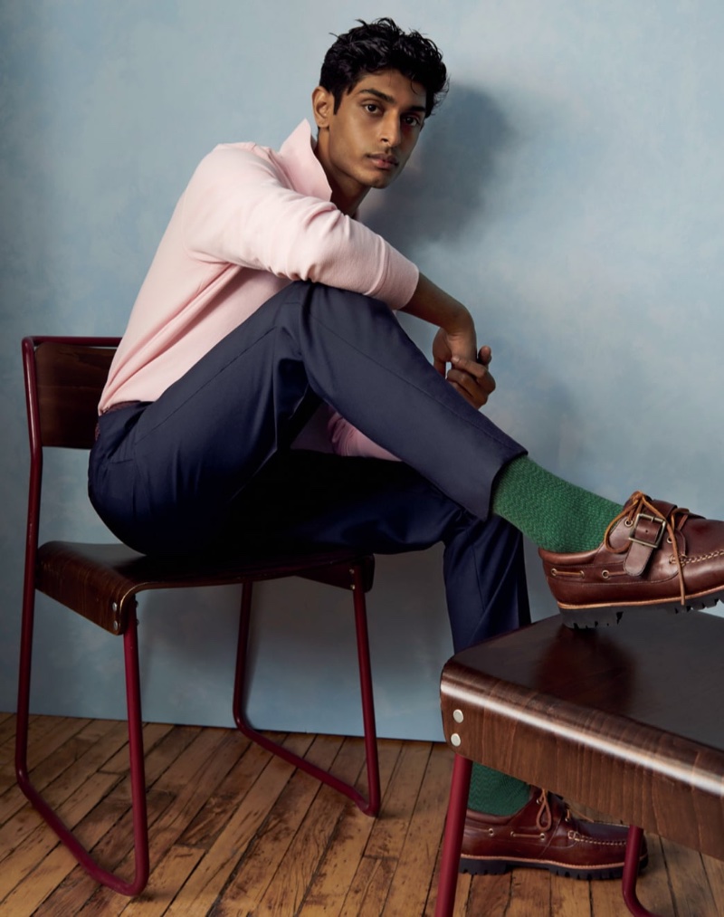 Model Pratik Shetty dons preppy style in a pink J.Crew piqué polo with pleated suit pants and buckle shoes.