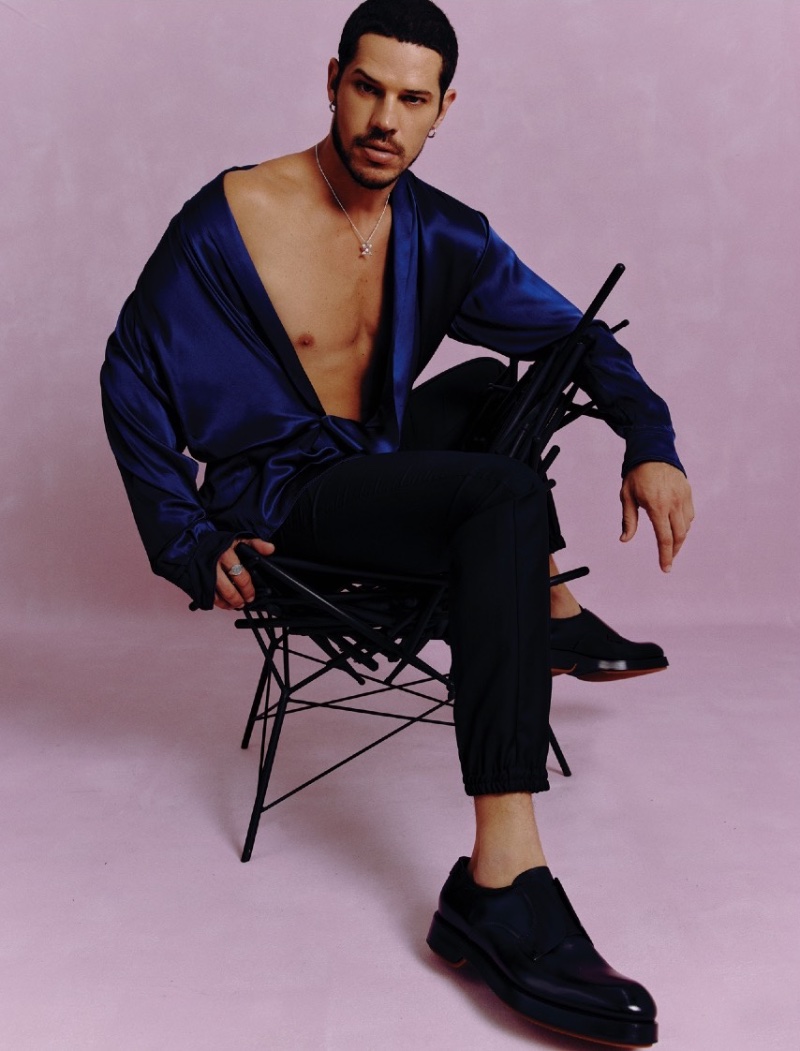 Sitting on a chair from Studio Stefanovicz, José Loreto wears silk shirt Dolce & Gabbana , pants Dior Men, shoes Zegna, and accessories Crayons Jewelry.