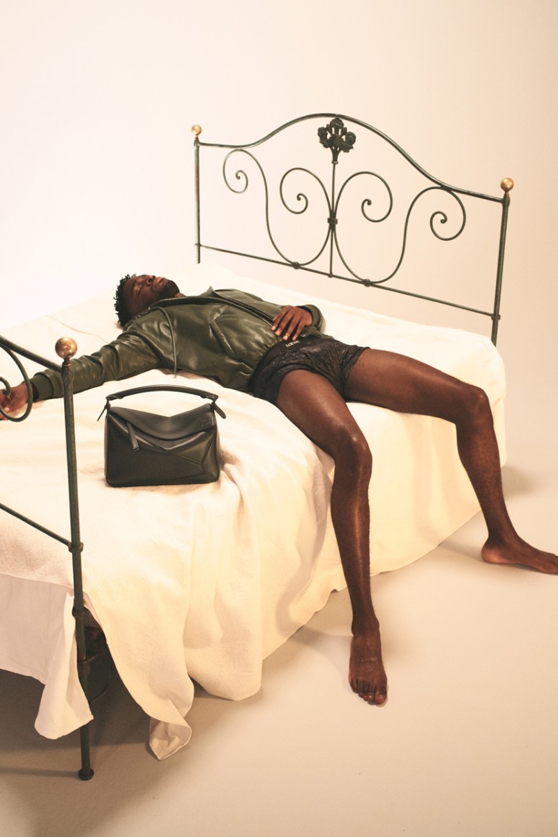Sprawled out in bed, Stéphane Bak fronts LOEWE's spring-summer 2023  campaign.