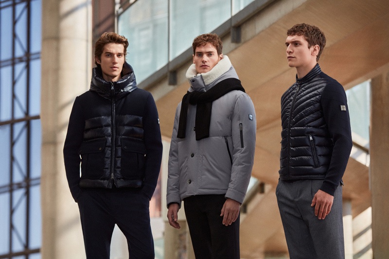 Models Aleksandr Blinov, Caspar Gonda, and George Admiraal sport dark-colored outerwear from Lufian. 
