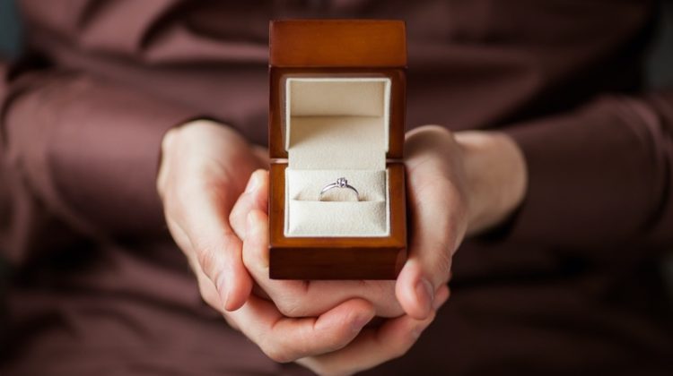 Man Holding Engagement Ring Brown Box