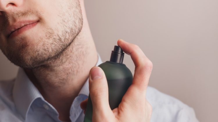 Man Spraying Cologne Closeup