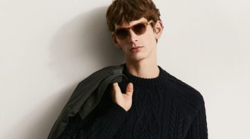 Erik van Gils sports black-on-black in a cable-knit sweater with pleated trousers.