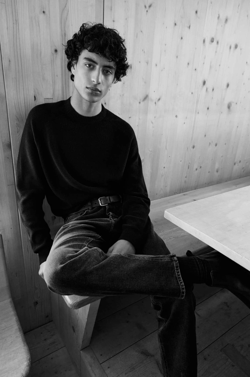 Embracing effortless style, Yoesry Detre wears a sweater with jeans and a leather belt.