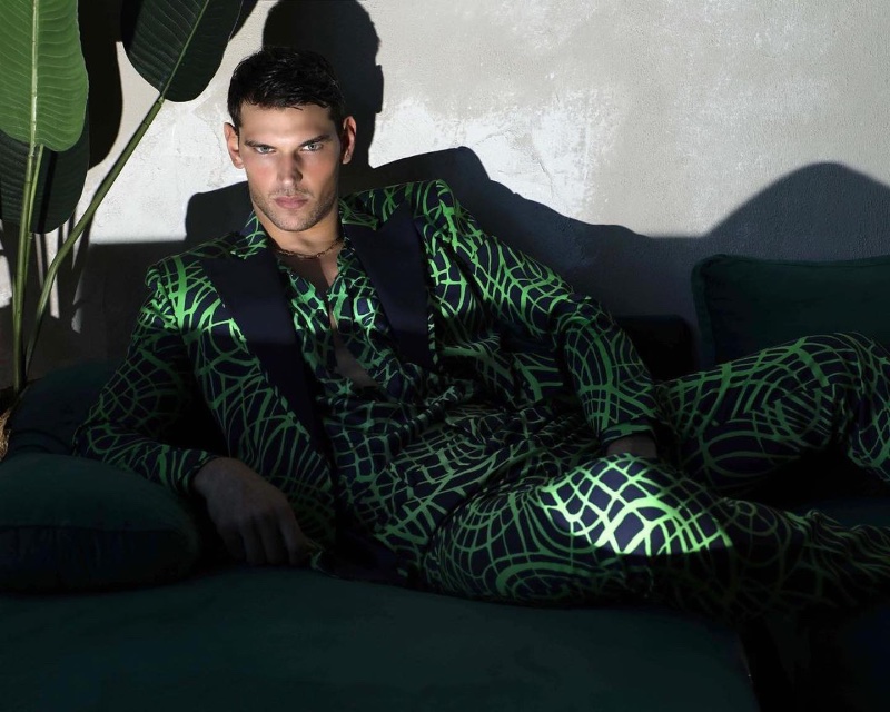 Making a statement in green and black, Stefano Marshall wears a printed suit from Moschino.