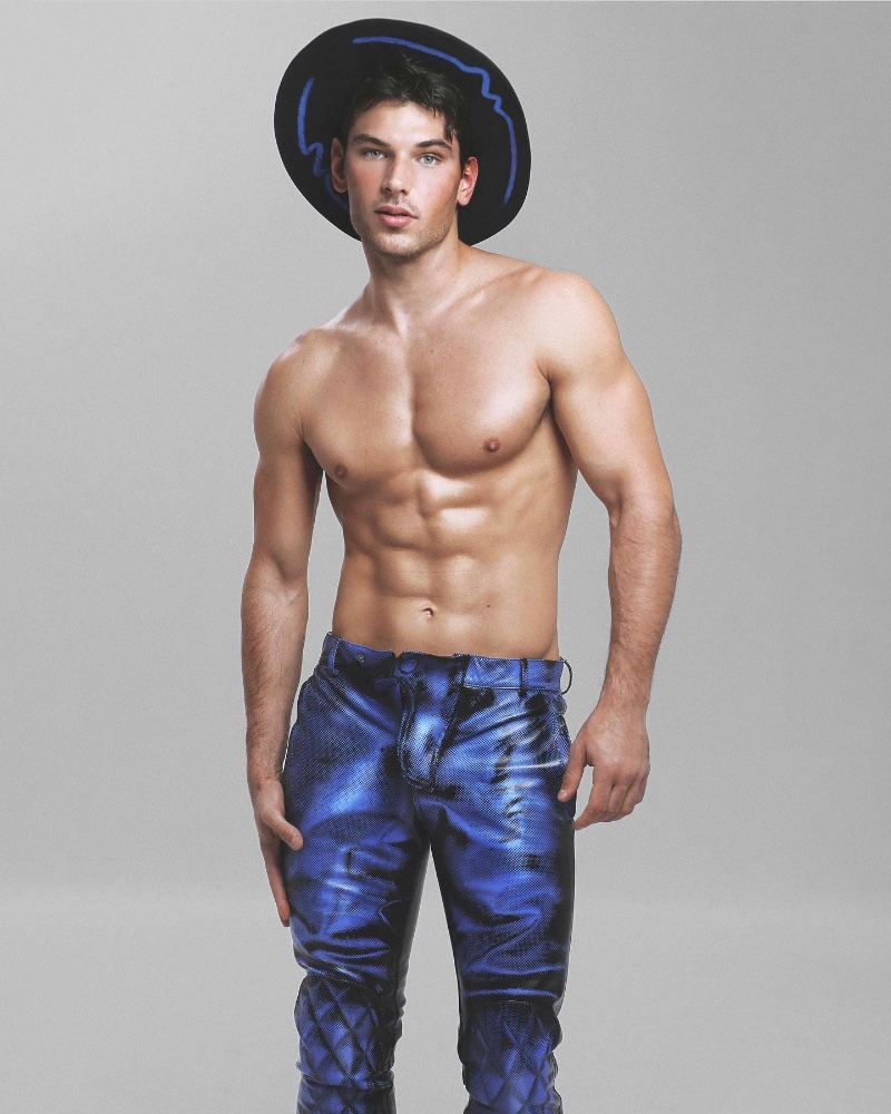 Opting for a shirtless look, Stefano Marshall stands out in Moschino's graphic leather pants. 