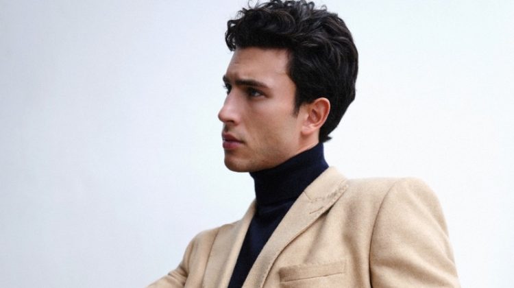 Mattia Narducci inspires in a sleek tan-colored double-breasted coat with a black turtleneck and navy trousers.
