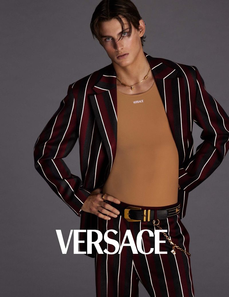 Mark Vanderloo Jr. takes the spotlight in a bold striped suit for Versace's spring-summer 2023 campaign for men. 