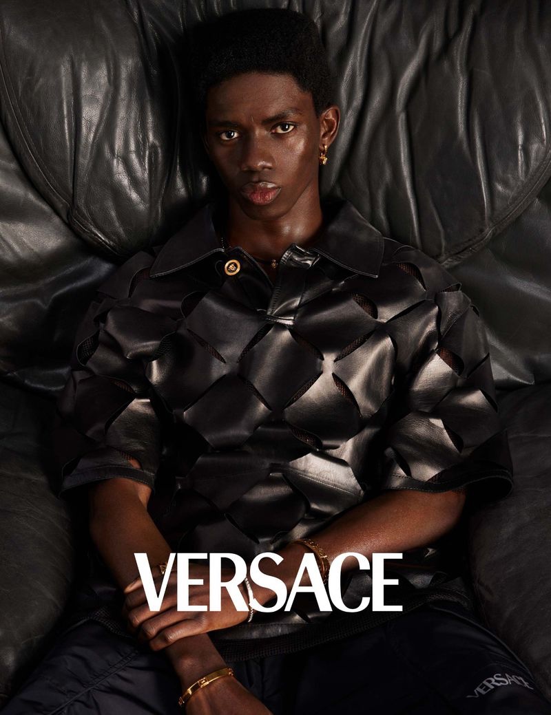 Ottawa Kwami wears a black leather laser-cut shirt for Versace's spring-summer 2023 men's campaign.