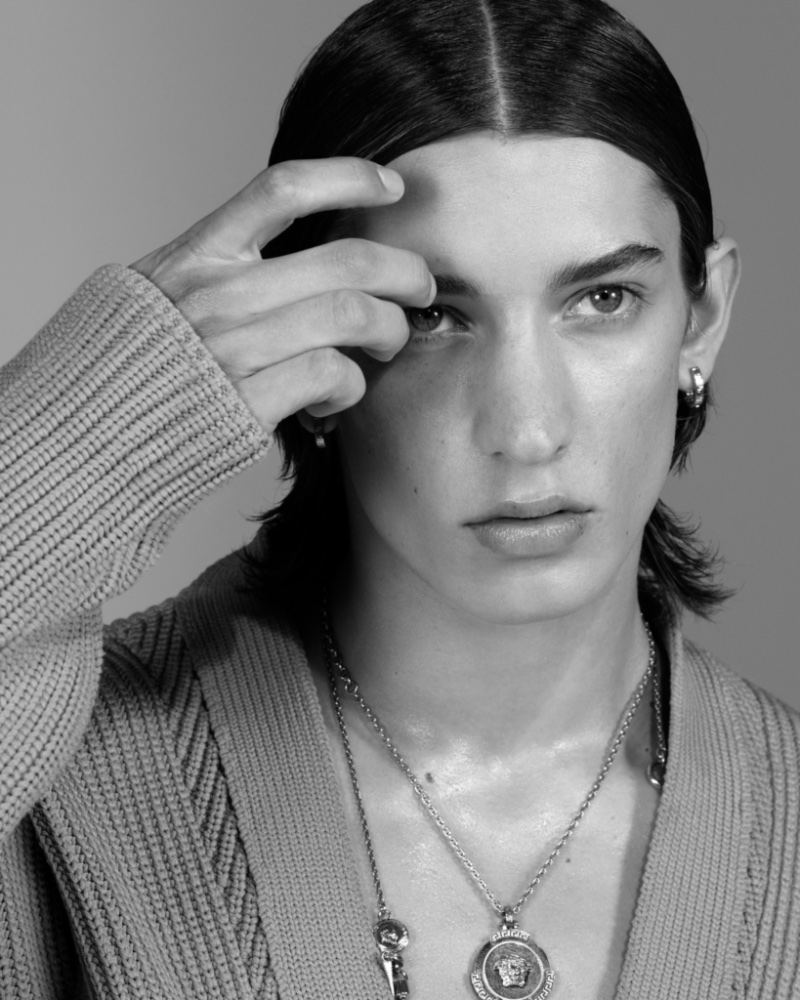 Fresh face Anthony Thomason wears a sleek center-part hairstyle for Versace's spring-summer 2023 men's campaign.